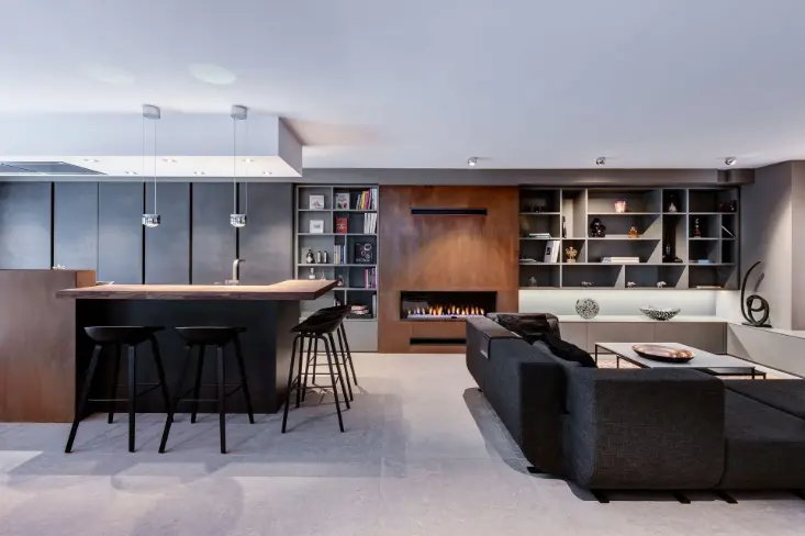 Modern kitchen and living room with black and brown furniture